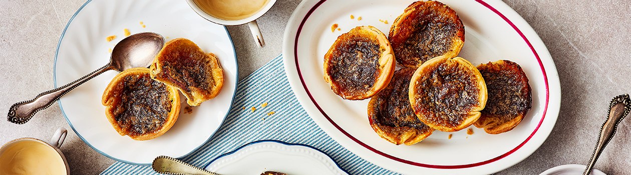 Overhead shot of plate of chocolate caramel butter tarts