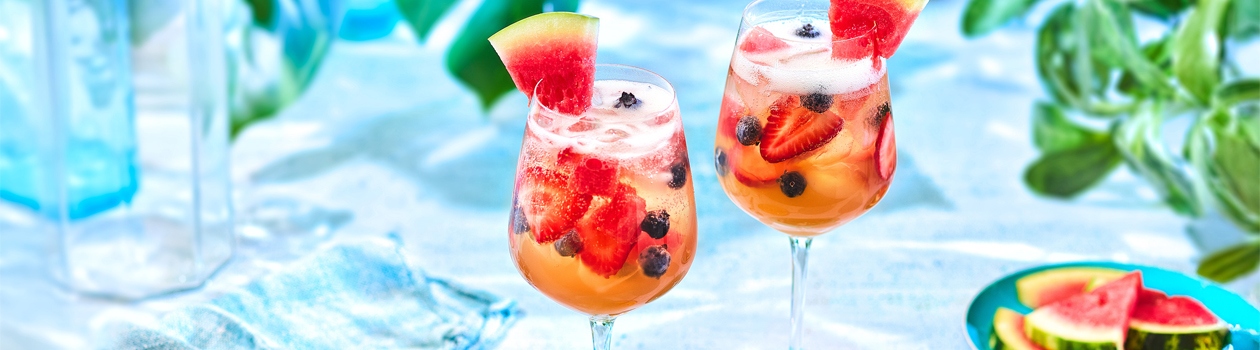 Lemonade iced tea sangria with fresh berries and watermelon.